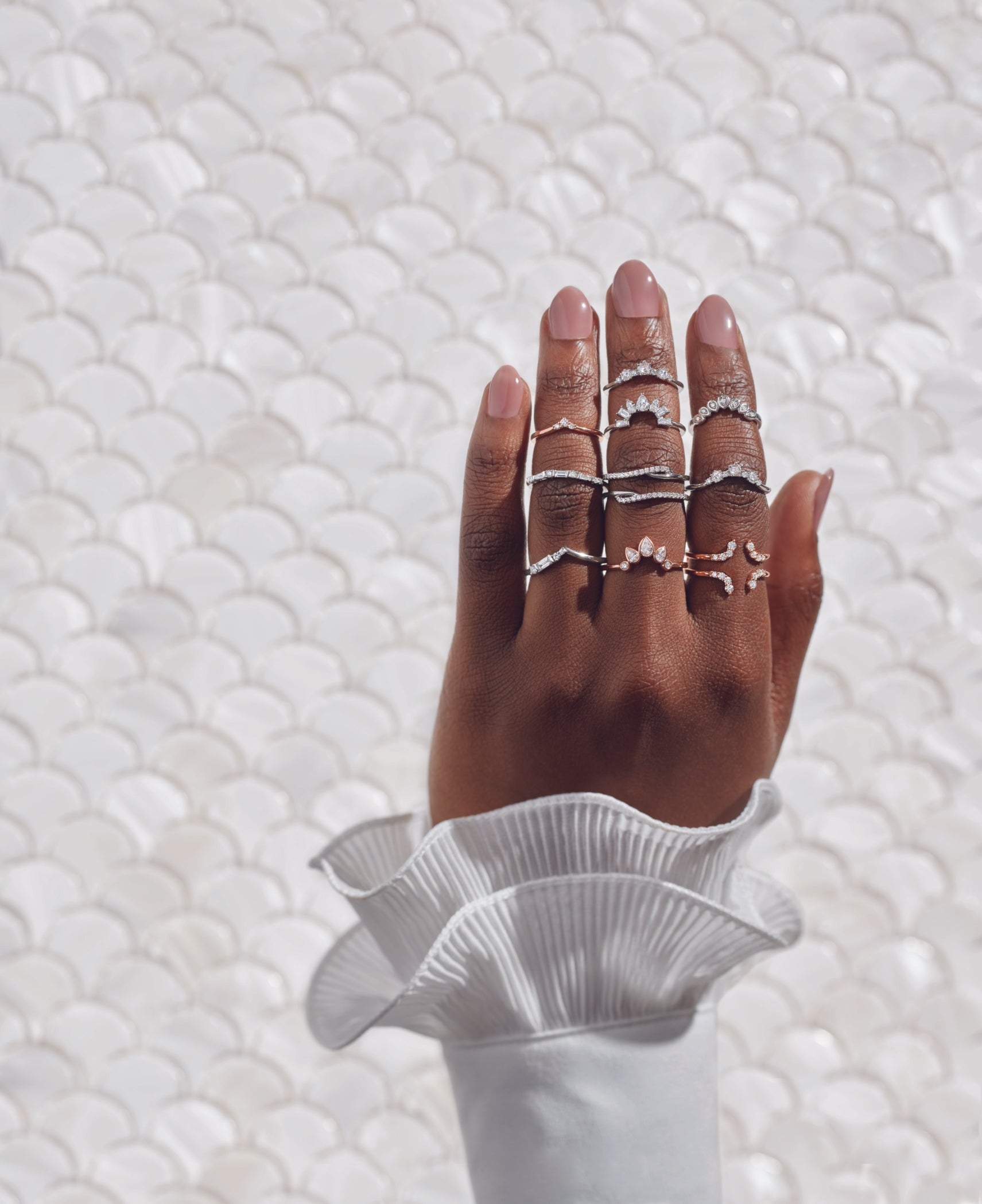 Hand adorned with elegant, stackable lab-grown diamond rings from JLab Jewelry, showcasing modern, sustainable, and eco-friendly fine jewelry designs.