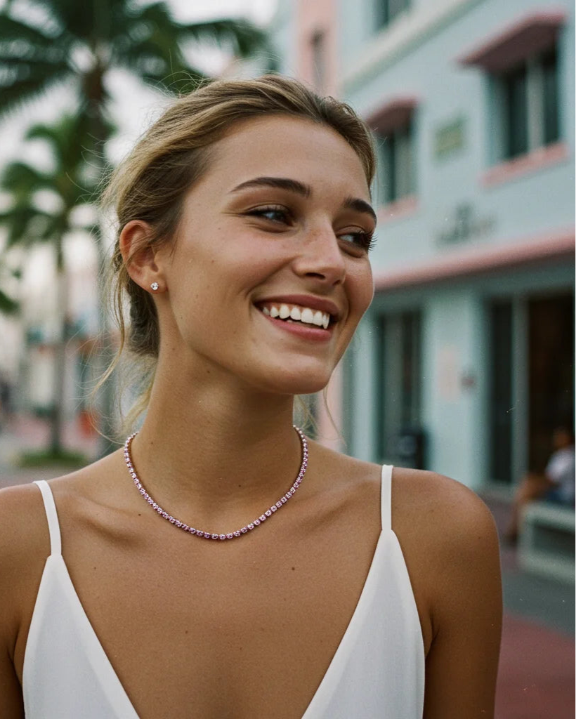 woman wear ruby tennis necklace, smiling 